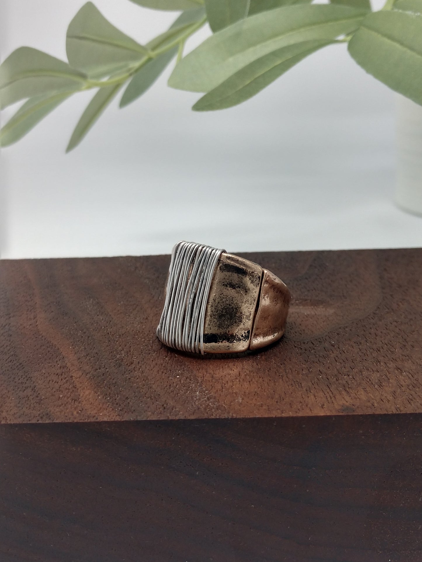 This simple yet stylish ring is a great mix of burnished gold tone with a burnished silver tone wire wrap made with a comfort stretch band. Up to .75" wide. Makes a great addition for your collection or would make a wonderful gift for a friend. No need to worry about their ring size due to the comfort stretch band.