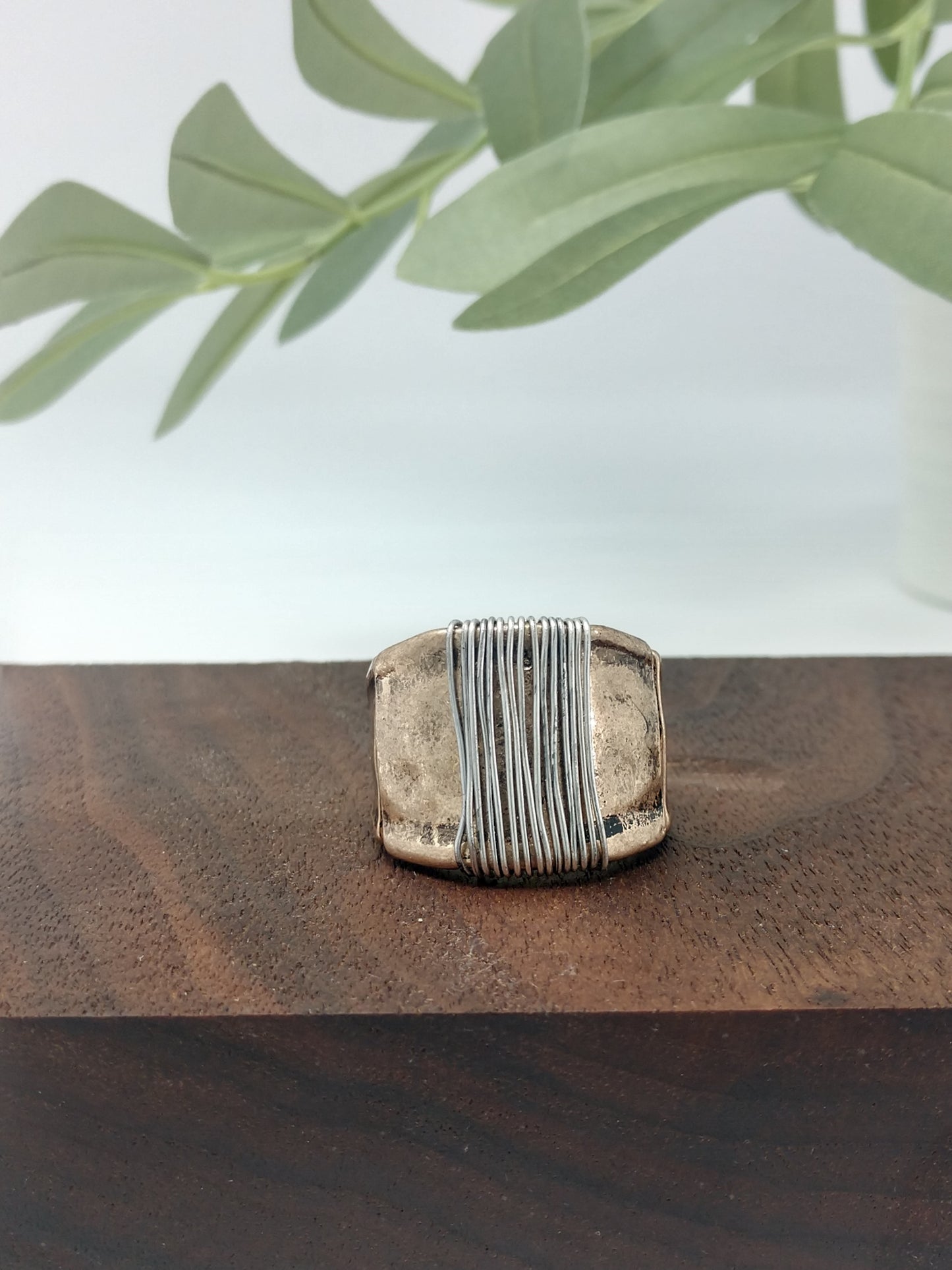 This simple yet stylish ring is a great mix of burnished gold tone with a burnished silver tone wire wrap made with a comfort stretch band. Up to .75" wide. Makes a great addition for your collection or would make a wonderful gift for a friend. No need to worry about their ring size due to the comfort stretch band.