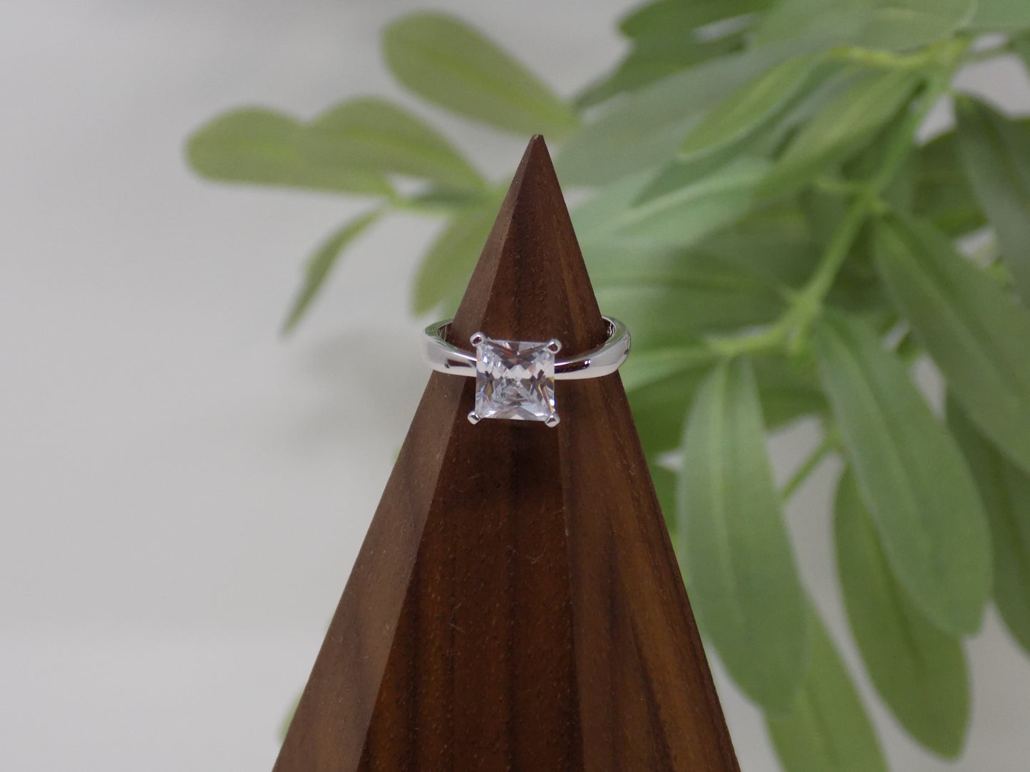 It is a 1.96ct cubic zirconia set in a high prong on a sterling silver band that is plated in rhodium to prevent tarnishing! Limited Quantity Our rings are in whole sizes only. We do carry ring sizers if you are an in between size. sterling silver rings, bands, wedding bands, stand in rings, placeholder rings, vacation rings, pregnancy rings, silver rings
