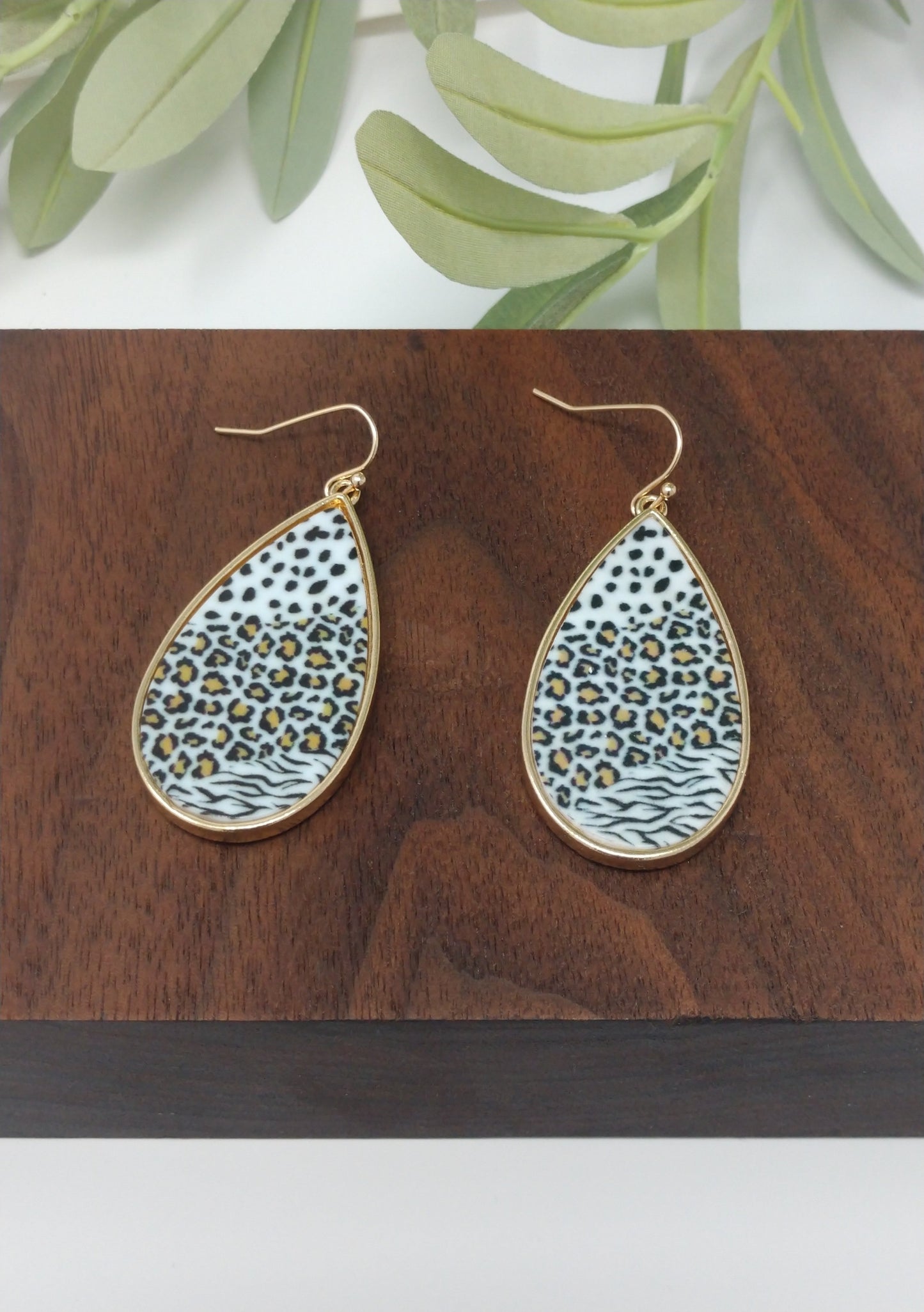 Tear drop earrings are always a good option especially when they are these gold tone trimmed white faux animal print plastic earring. They are a 2" fish hook style earring with a 1.75" drop. Fashion jewelry, affordable accessories