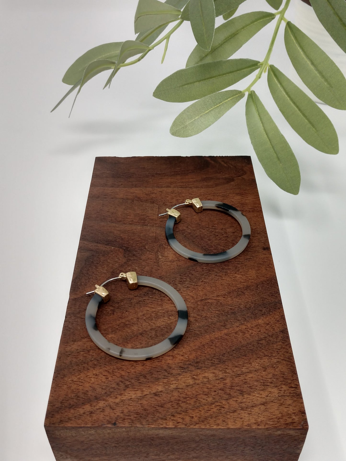 These trendy gray tortoiseshell hoop earring would be a great compliment to your outfit and a wonderful gift idea for a friend. They are worn gold tone faux tortoiseshell hoop earrings with a snap-lock backs. They measure approximately 1.5".