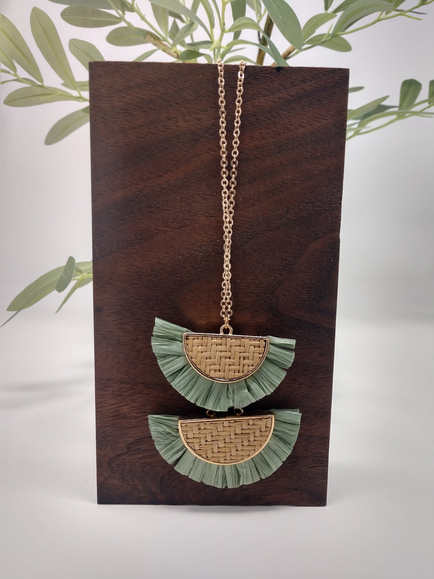 It would be a unique piece to accessorize with and would make a cool gift for a family member, friend or loved one. It is a 30" long gold tone necklace with a 3" extender and lobster claw closure. It is made with rattan, and raffia material. The pendant measures 2.5" and is so delicate feeling. Plus, it comes with the most perfect set of earrings. They are .75" fish hook style with a .25 drop.Fashion jewelry is a great way to add affordable fun, colorful, trendy pieces to your collection.