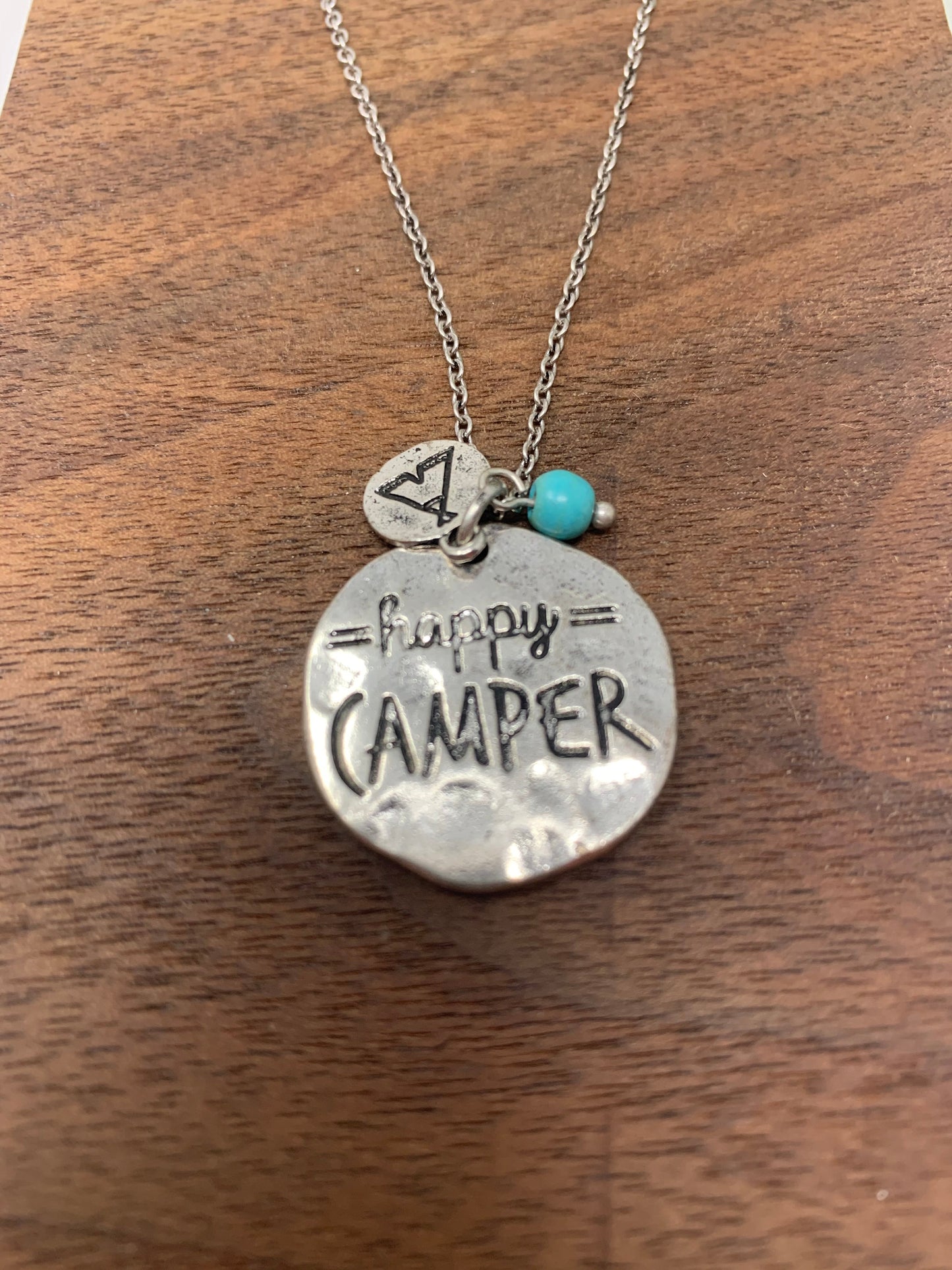 This beauty is a Silver tone chain and pendant measures approximately 9.5" with a 2" extender. The pendant says happy camper and there is a small charm with a stamped teepee image that hangs over the top of the pendant. It also comes with matching earrings!