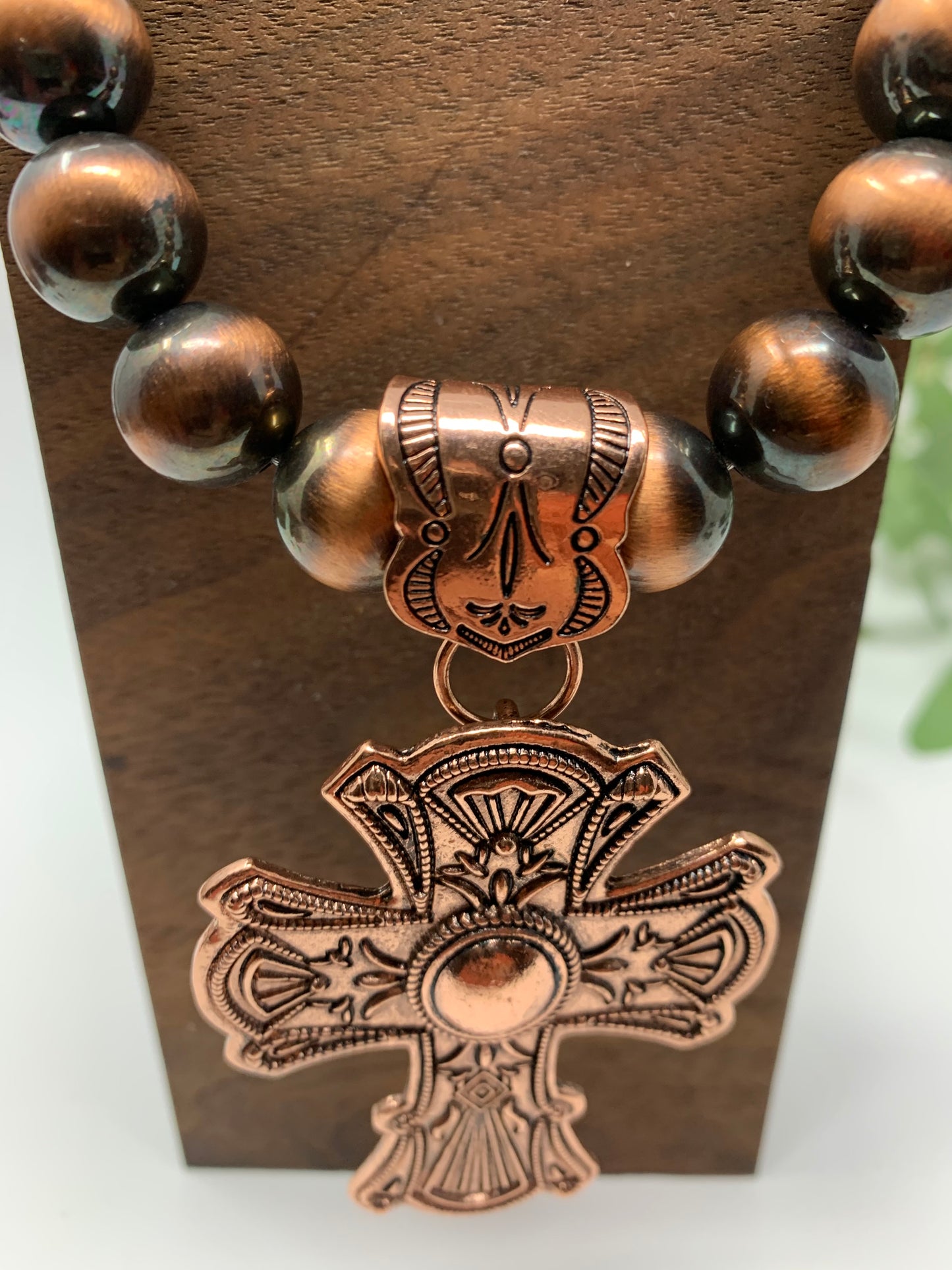 The bronze tone cross is so bright and engraved. The beads that make up the necklace are a bronze tone and black, same as the earrings. Necklace measures 12" in total length including the charm.Fashion jewelry is a great way to add affordable fun, colorful, trendy pieces to your collection.