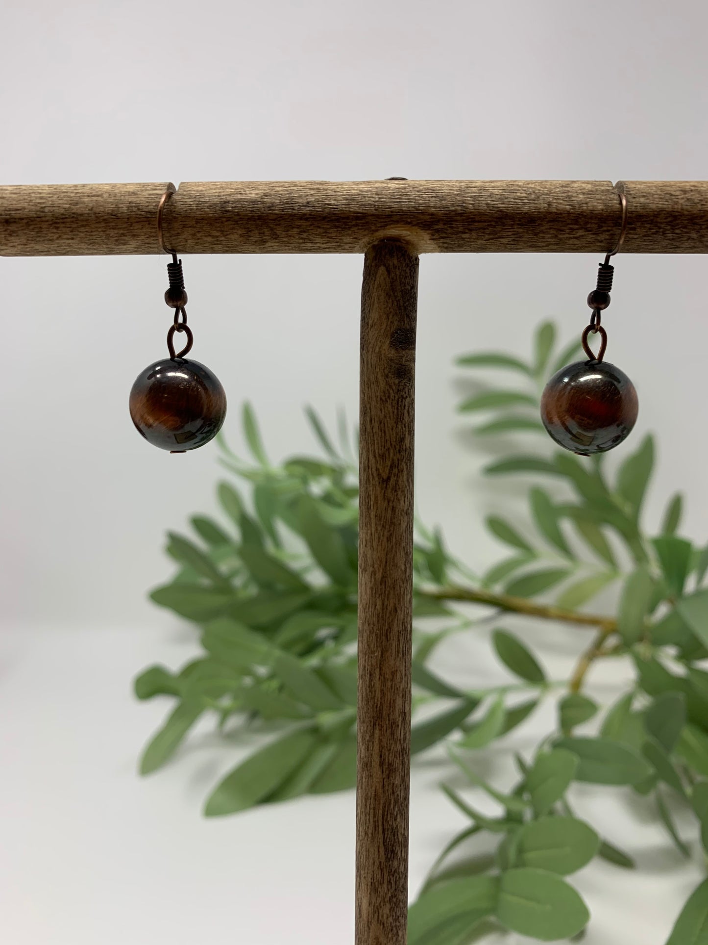 The bronze tone cross is so bright and engraved. The beads that make up the necklace are a bronze tone and black, same as the earrings. Necklace measures 12" in total length including the charm.Fashion jewelry is a great way to add affordable fun, colorful, trendy pieces to your collection.