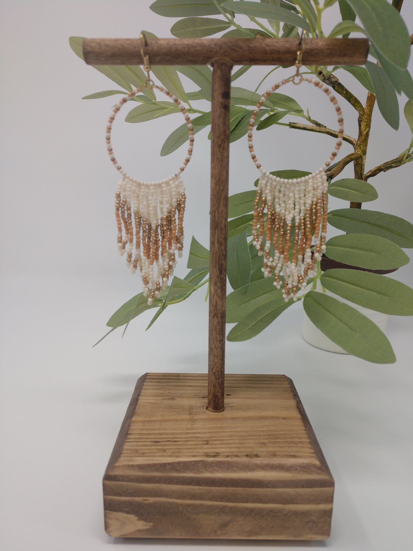 Seed beads are becoming a trendy theme. They would be a great gift to the earring lover as well. They are approximately 4.5" fish hook style earrings with a 3.75" drop. The seed beads are ivory and gold tone with gold tone hardware.