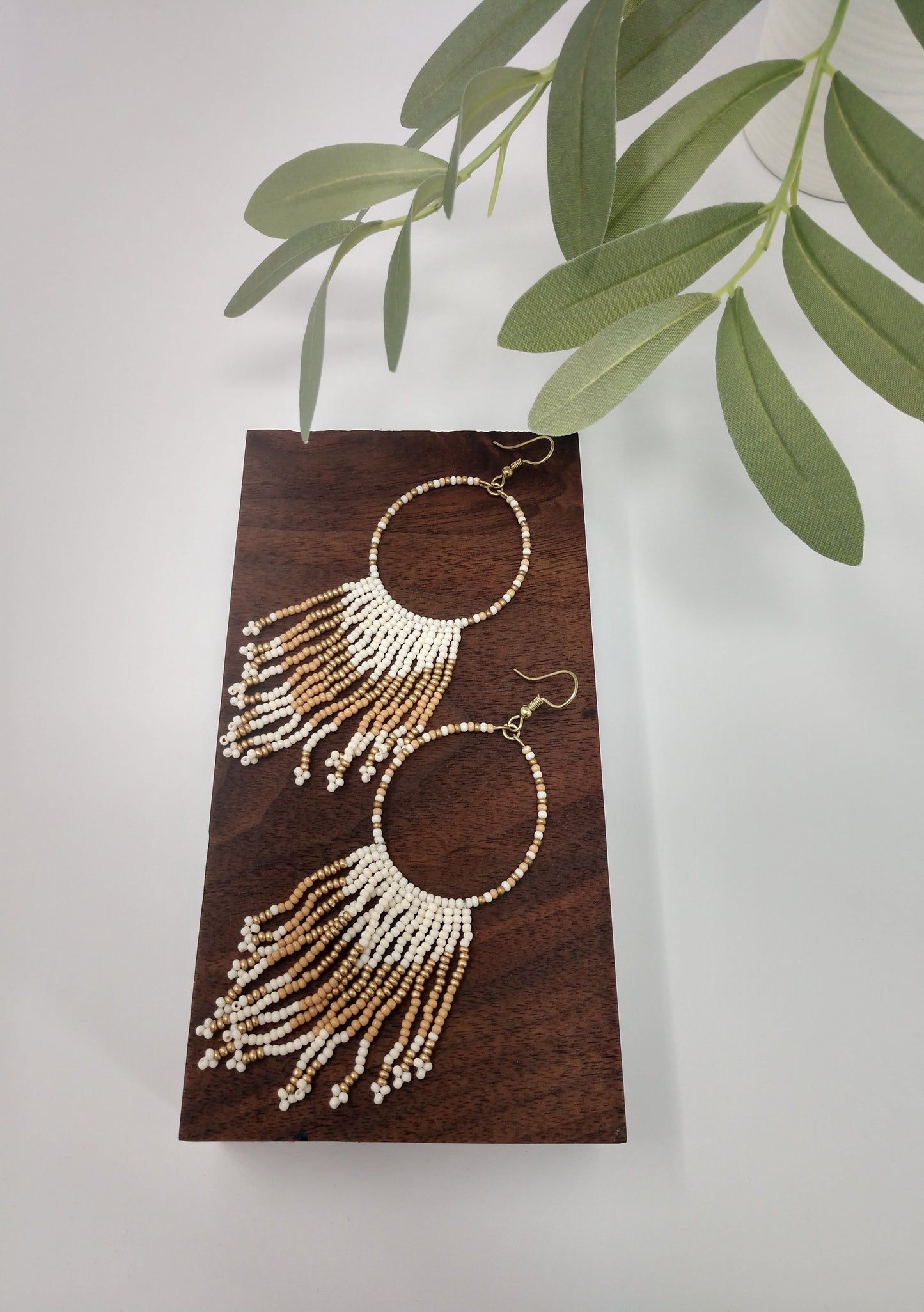 Seed beads are becoming a trendy theme. They would be a great gift to the earring lover as well. They are approximately 4.5" fish hook style earrings with a 3.75" drop. The seed beads are ivory and gold tone with gold tone hardware.