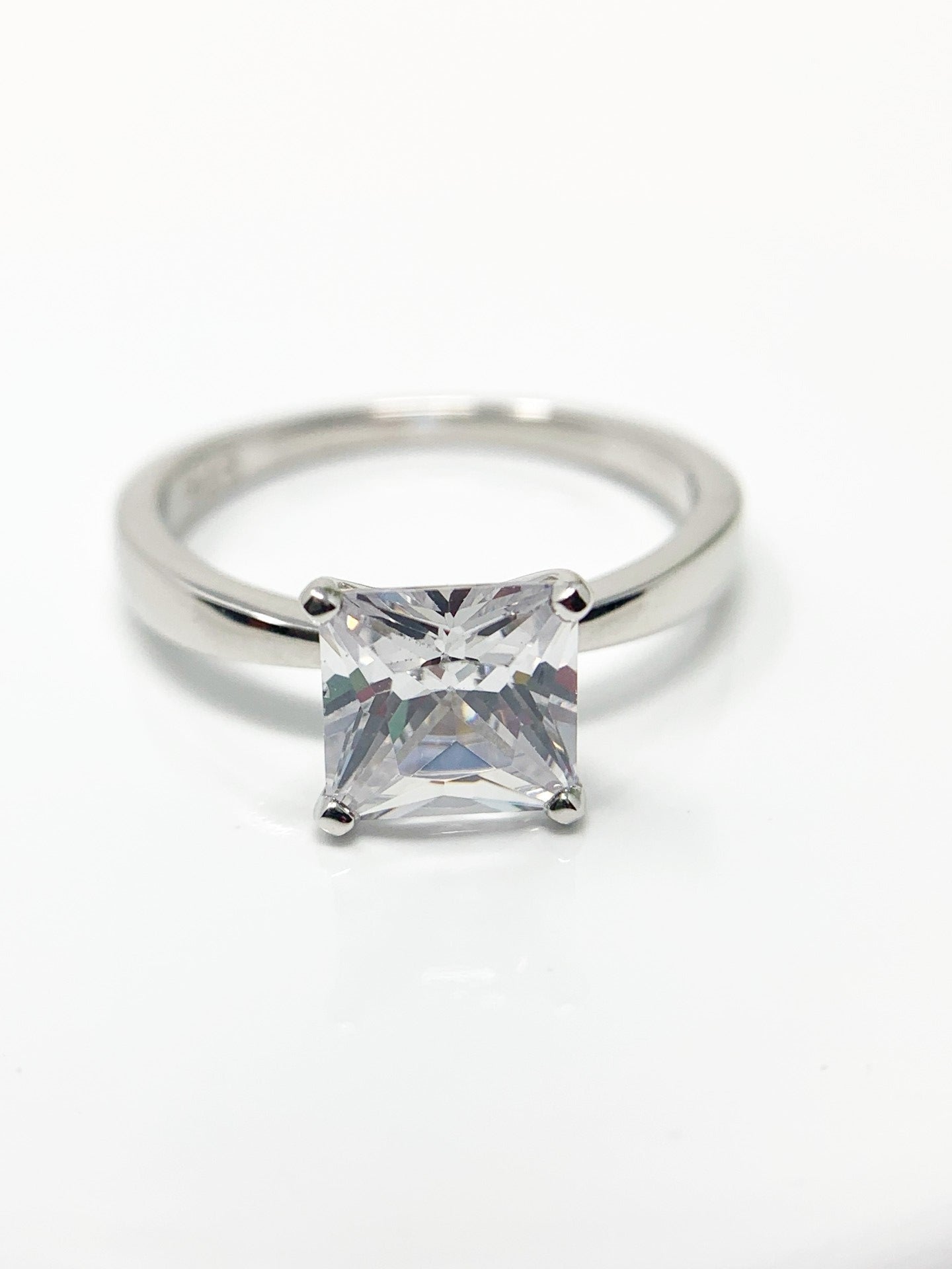 Do you love the classic look of the solitaire princess cut rings? This may be the perfect ring for you! It is gorgeous and offers that classic, timeless charm. Great gift, treat yourself! It is a 1.96ct cubic zirconia set in a high prong on a sterling silver band that is plated in rhodium to prevent tarnishing! Limited Quantity Our rings are in whole sizes only. We do carry ring sizers if you are an in between size.