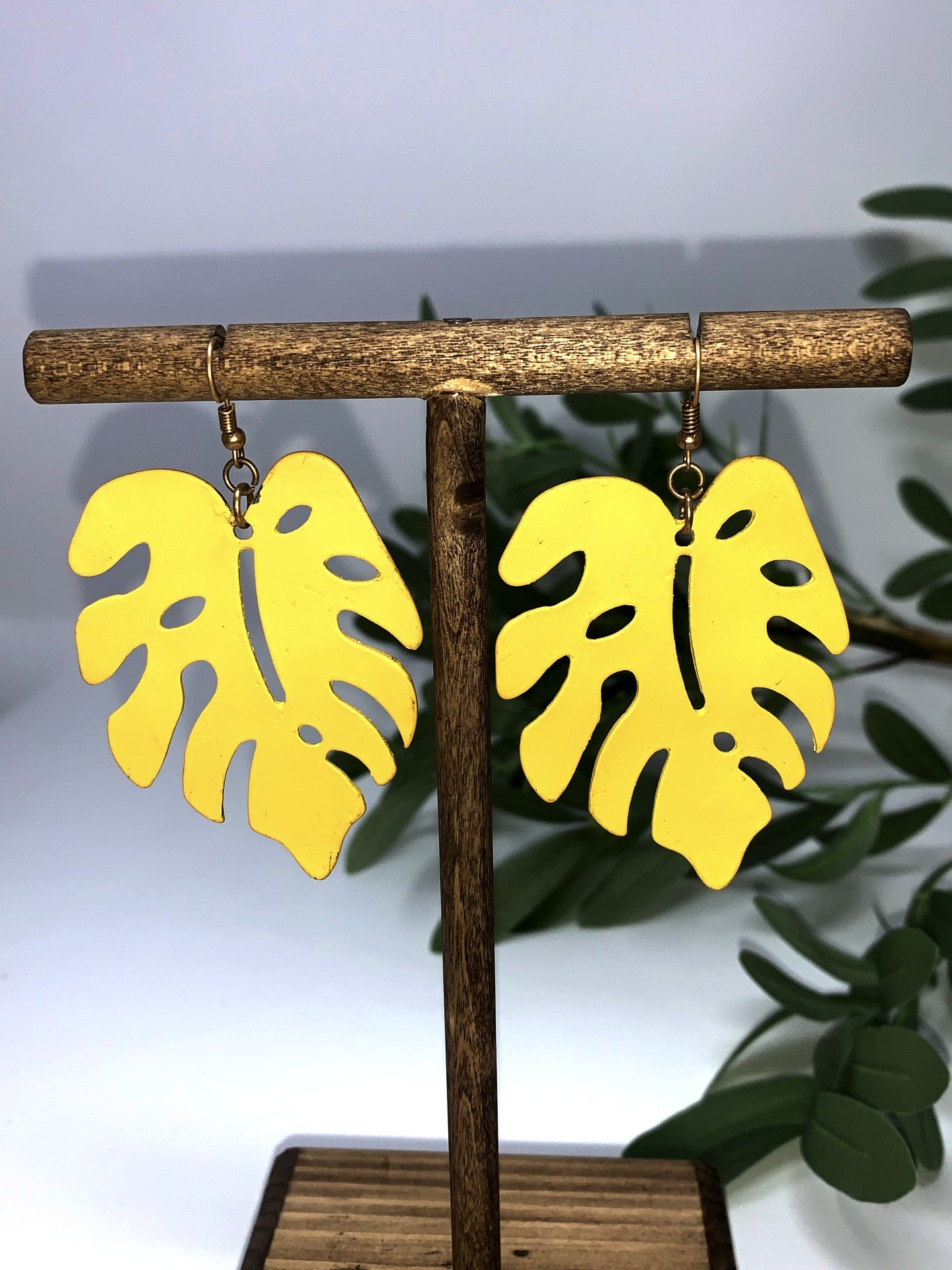 Tropical leaf hook earrings, metal and weigh 1oz each. They are not light weight.