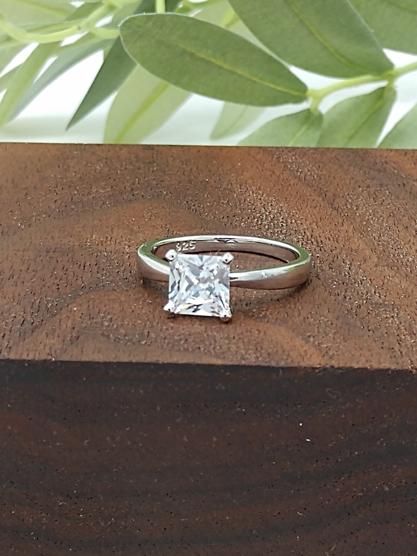 Do you love the classic look of the solitaire princess cut rings? This may be the perfect ring for you! It is gorgeous and offers that classic, timeless charm. Great gift, treat yourself! It is a 1.96ct cubic zirconia set in a high prong on a sterling silver band that is plated in rhodium to prevent tarnishing! Limited Quantity Our rings are in whole sizes only. We do carry ring sizers if you are an in between size.
