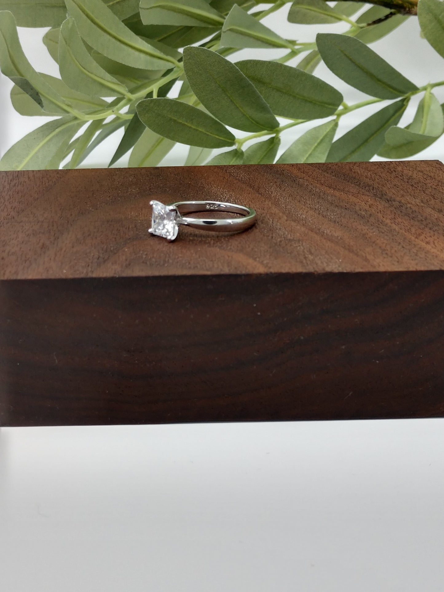 Do you love the classic look of the solitaire princess cut rings? This may be the perfect ring for you! It is gorgeous and offers that classic, timeless charm. Great gift, treat yourself! It is a 1.96ct cubic zirconia set in a high prong on a sterling silver band that is plated in rhodium to prevent tarnishing! Limited Quantity Our rings are in whole sizes only. We do carry ring sizers if you are an in between size.