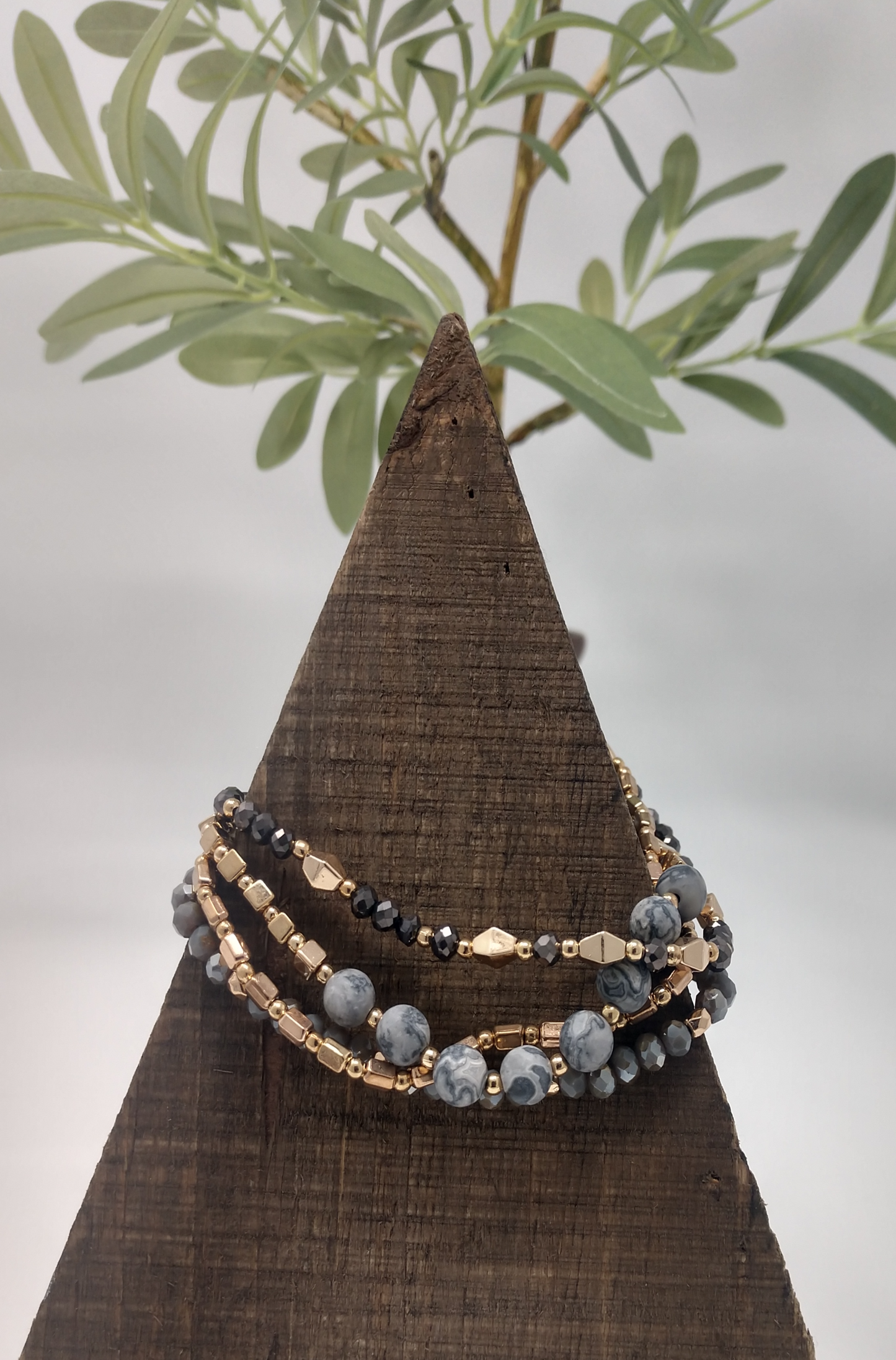 This bracelet is so perfect. It has four strands of gray Jasper and gold tone beads. The mix of faceted and smooth beads offers a neat mix especially being paired with the round, cube, rectangle and double pyramid beads. This is a pull adjustable cord bracelet so there is no clasp closure.