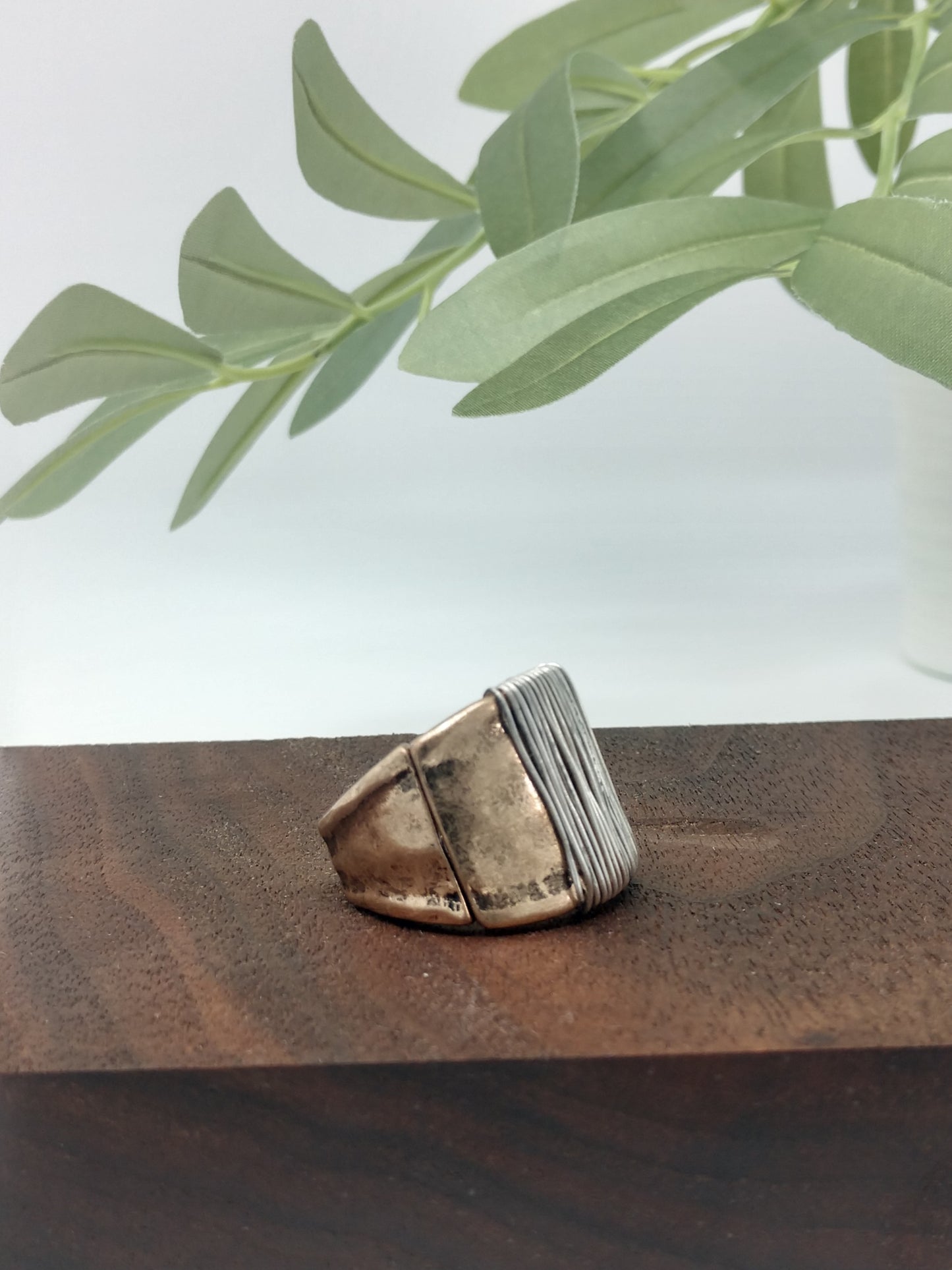 This simple yet stylish ring is a great mix of burnished gold tone with a burnished silver tone wire wrap made with a comfort stretch band. Up to .75" wide. Makes a great addition for your collection or would make a wonderful gift for a friend. No need to worry about their ring size due to the comfort stretch band. 