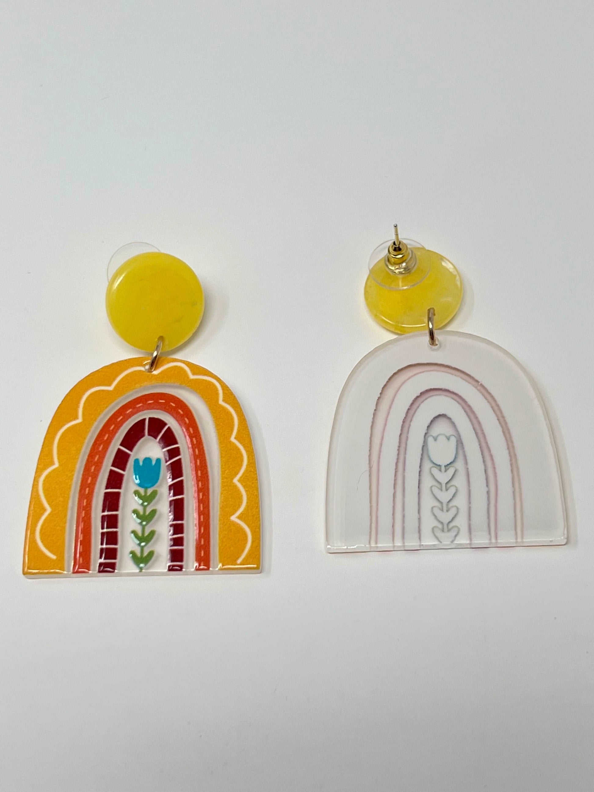 These beautiful and colorful rainbow earrings are acrylic with a post style backing and gold tone hardware. Photo shows back of earring. 