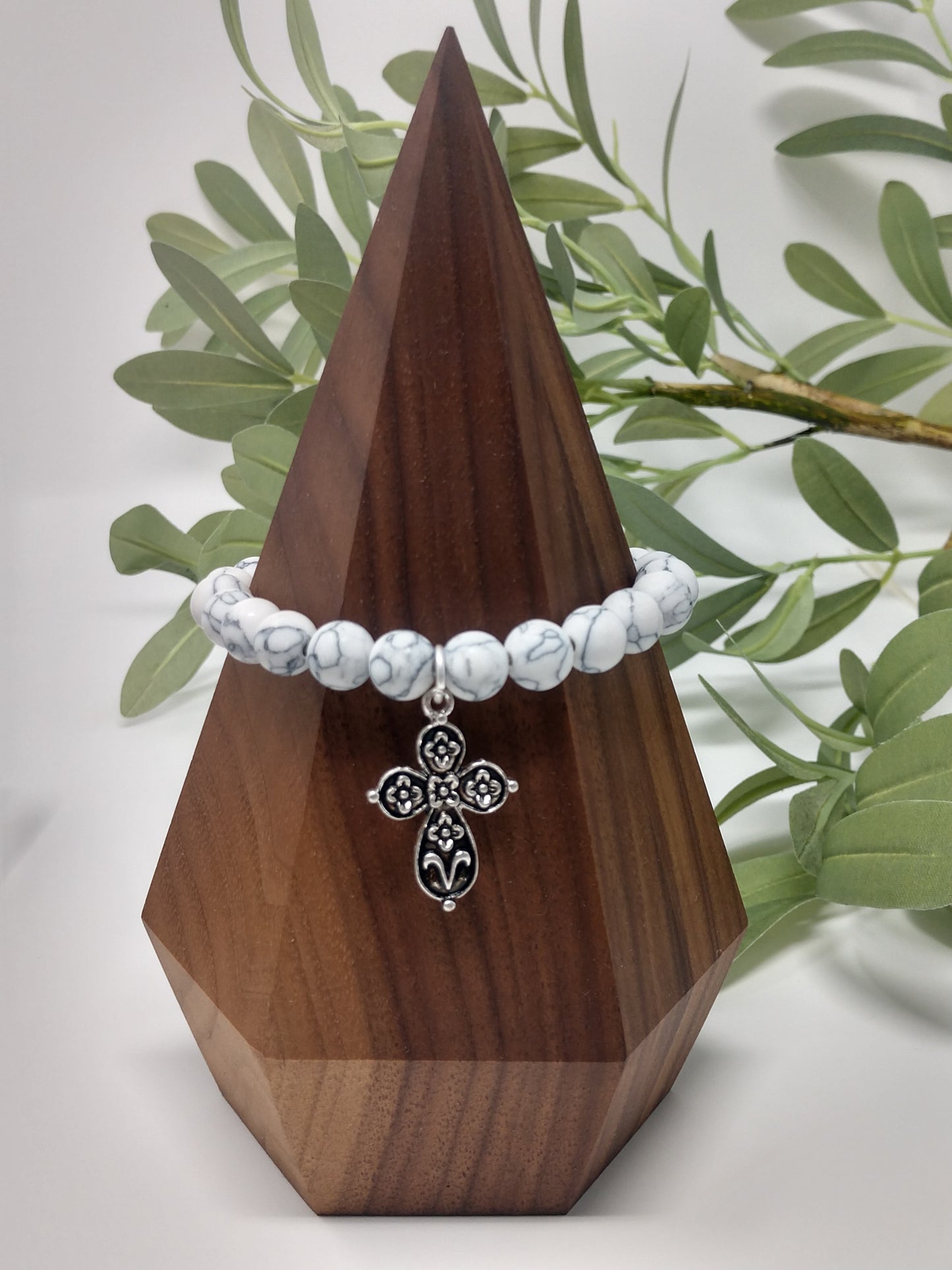 The faux stones, worn silver tone, and metal beads go together so beautifully. There is also a 1.5" engraved metal cube. A .75" heart charm and a 1" floral cross charm. Each bracelet is a comfort stretch so there is no closure. That allows for easy on and off. 2.25" diameter.  