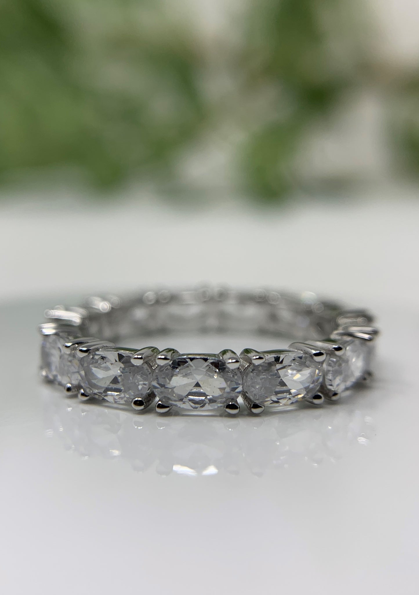 beautiful oval cubic zirconia diamonds make the ring. 925 Sterling Silver that is high polished and rhodium plated to prevent tarnishing. 13 simulated oval diamonds in a prong setting make up this beauty totaling .21carats.   Limited Quantity.  Our rings are in whole sizes only. 