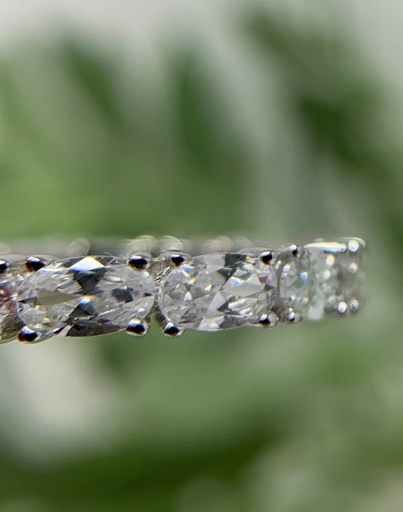 stackable ring, stylish and matches so much. 925 Sterling Silver that is high polished and rhodium plated to prevent tarnishing. 13 simulated oval diamonds in a prong setting make up this beauty totaling .21carats.   Limited Quantity.  Our rings are in whole sizes only. 