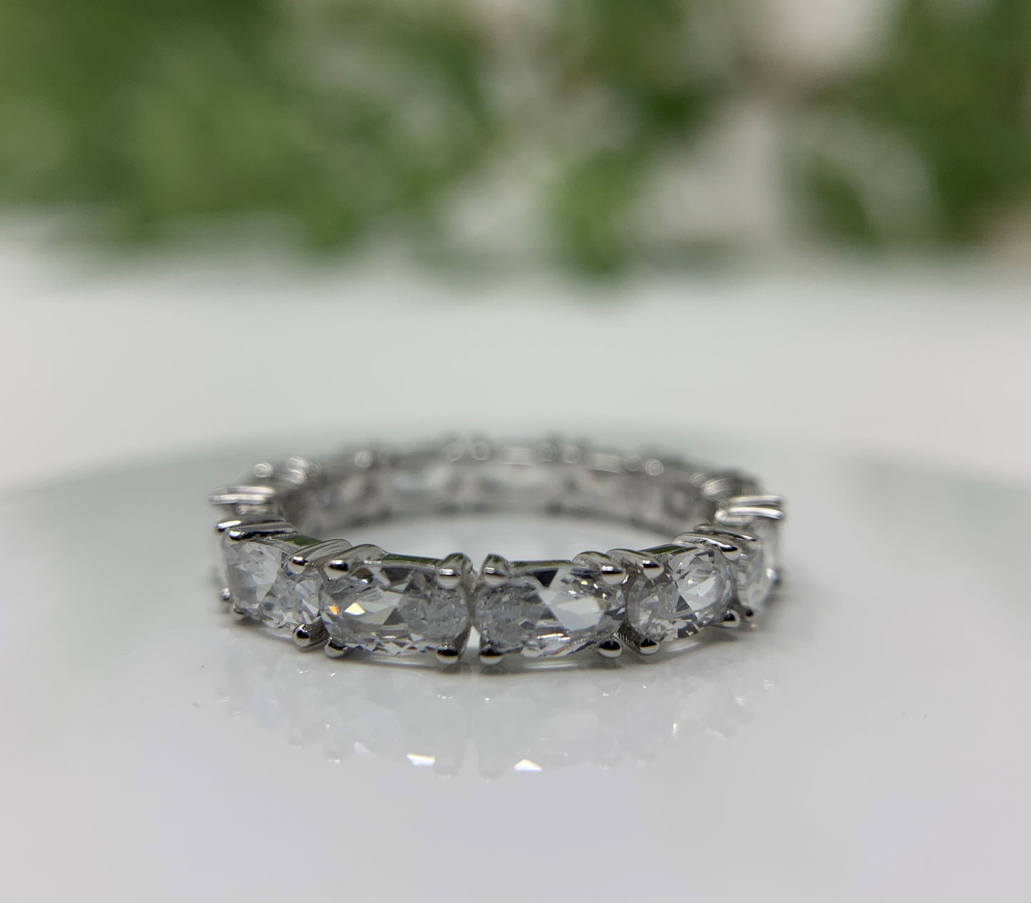 925 Sterling Silver that is high polished and rhodium plated to prevent tarnishing. 13 simulated oval diamonds in a prong setting make up this beauty totaling .21carats.   Limited Quantity.  Our rings are in whole sizes only. 