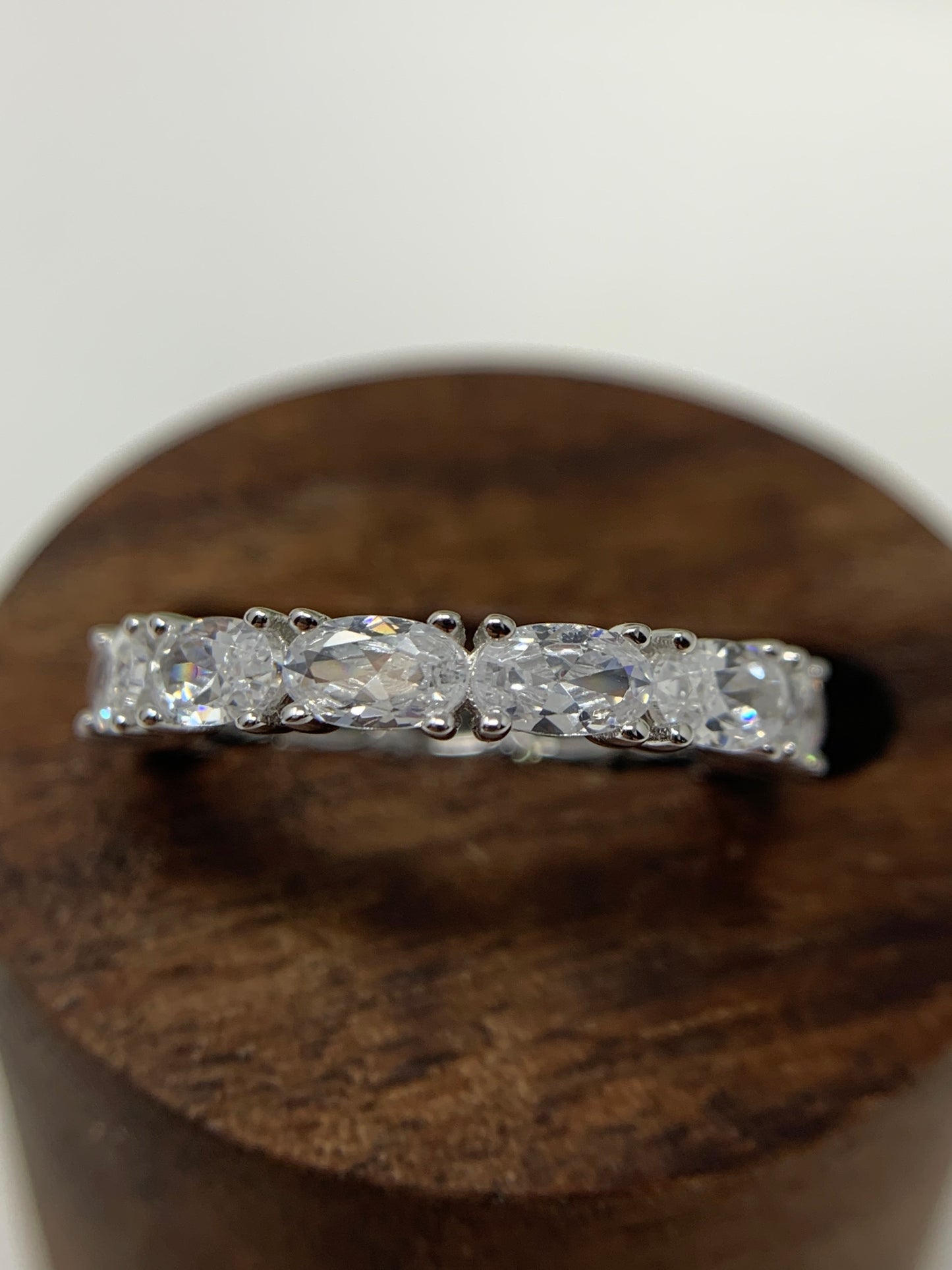 925 Sterling Silver that is high polished and rhodium plated to prevent tarnishing. 13 simulated oval diamonds in a prong setting make up this beauty totaling .21carats.   Limited Quantity.  Our rings are in whole sizes only. 