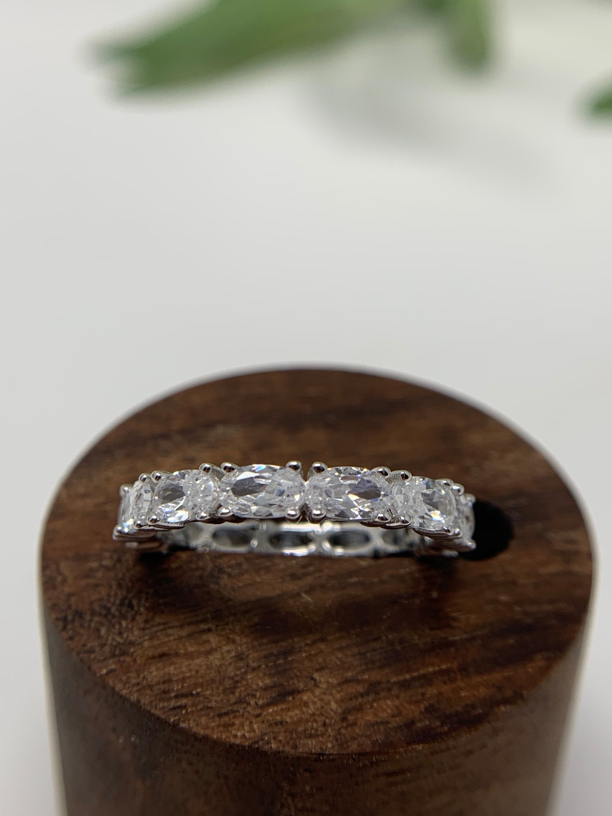 925 Sterling Silver that is high polished and rhodium plated to prevent tarnishing. 13 simulated oval diamonds in a prong setting make up this beauty totaling .21carats.   Limited Quantity.  Our rings are in whole sizes only. 