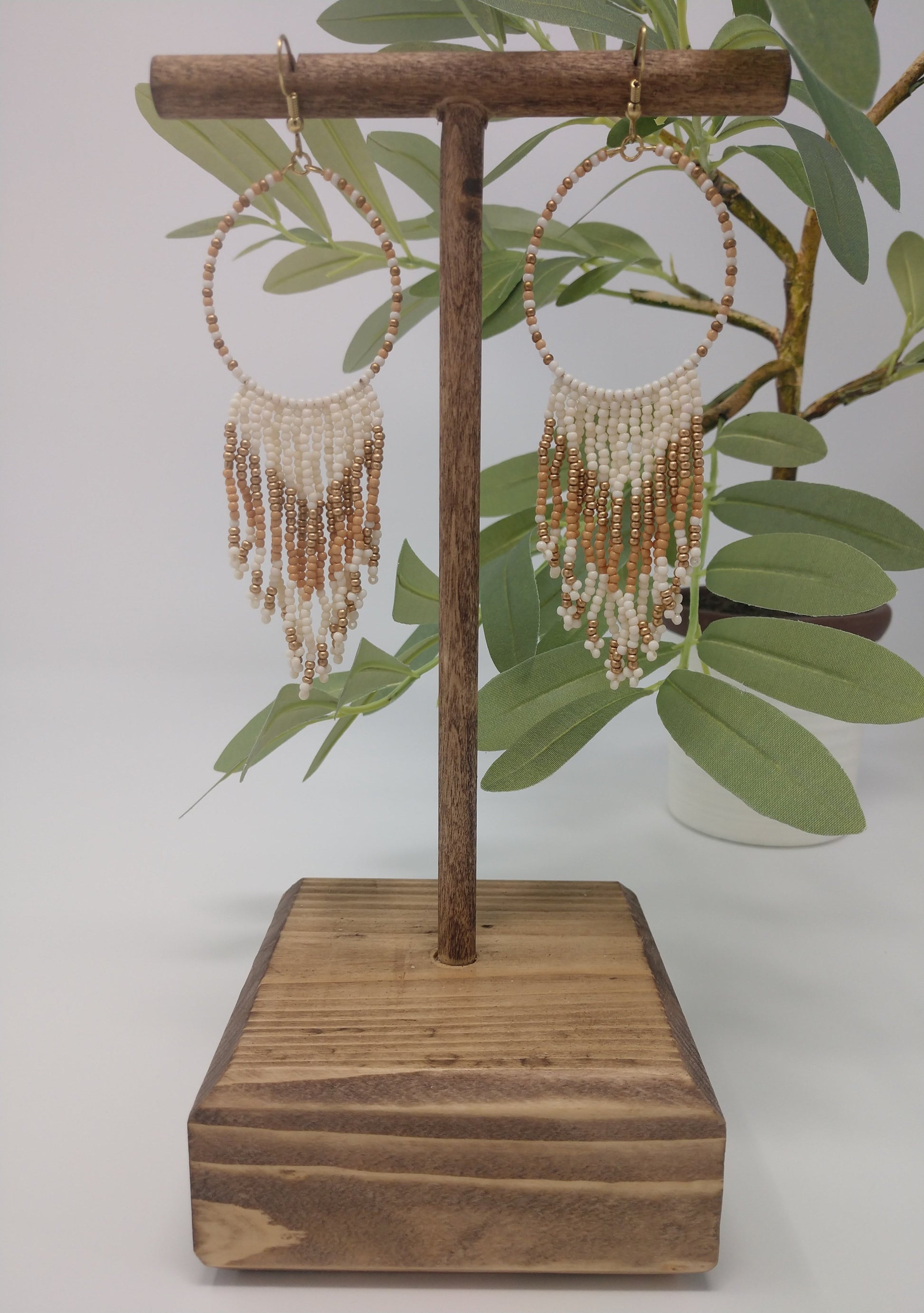  Seed beads are becoming a trendy theme. They would be a great gift to the earring lover as well.  They are approximately 4.5" fish hook style earrings with a 3.75" drop. The seed beads are ivory and gold tone with gold tone hardware. 
