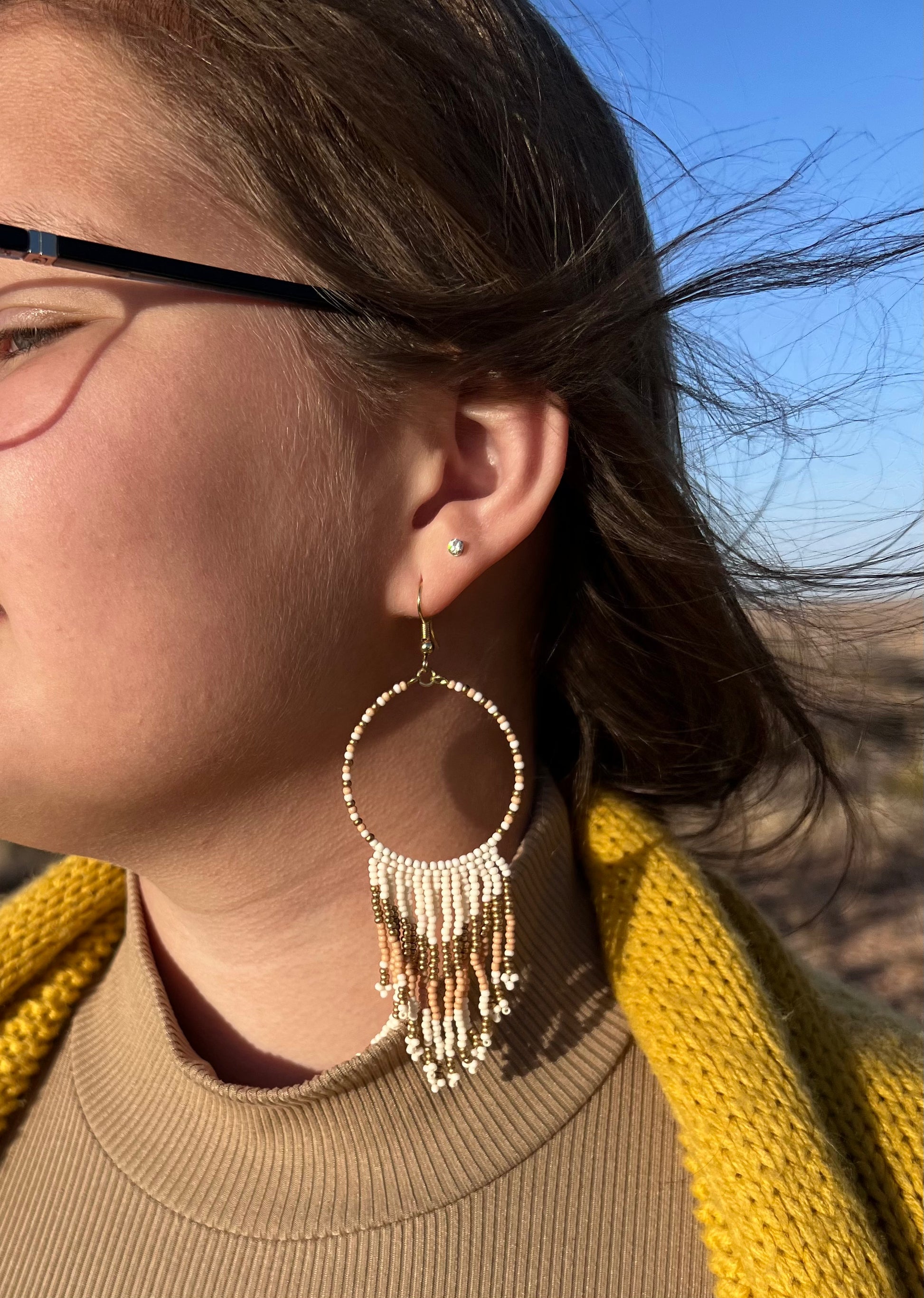  Seed beads are becoming a trendy theme. They would be a great gift to the earring lover as well.  They are approximately 4.5" fish hook style earrings with a 3.75" drop. The seed beads are ivory and gold tone with gold tone hardware. 