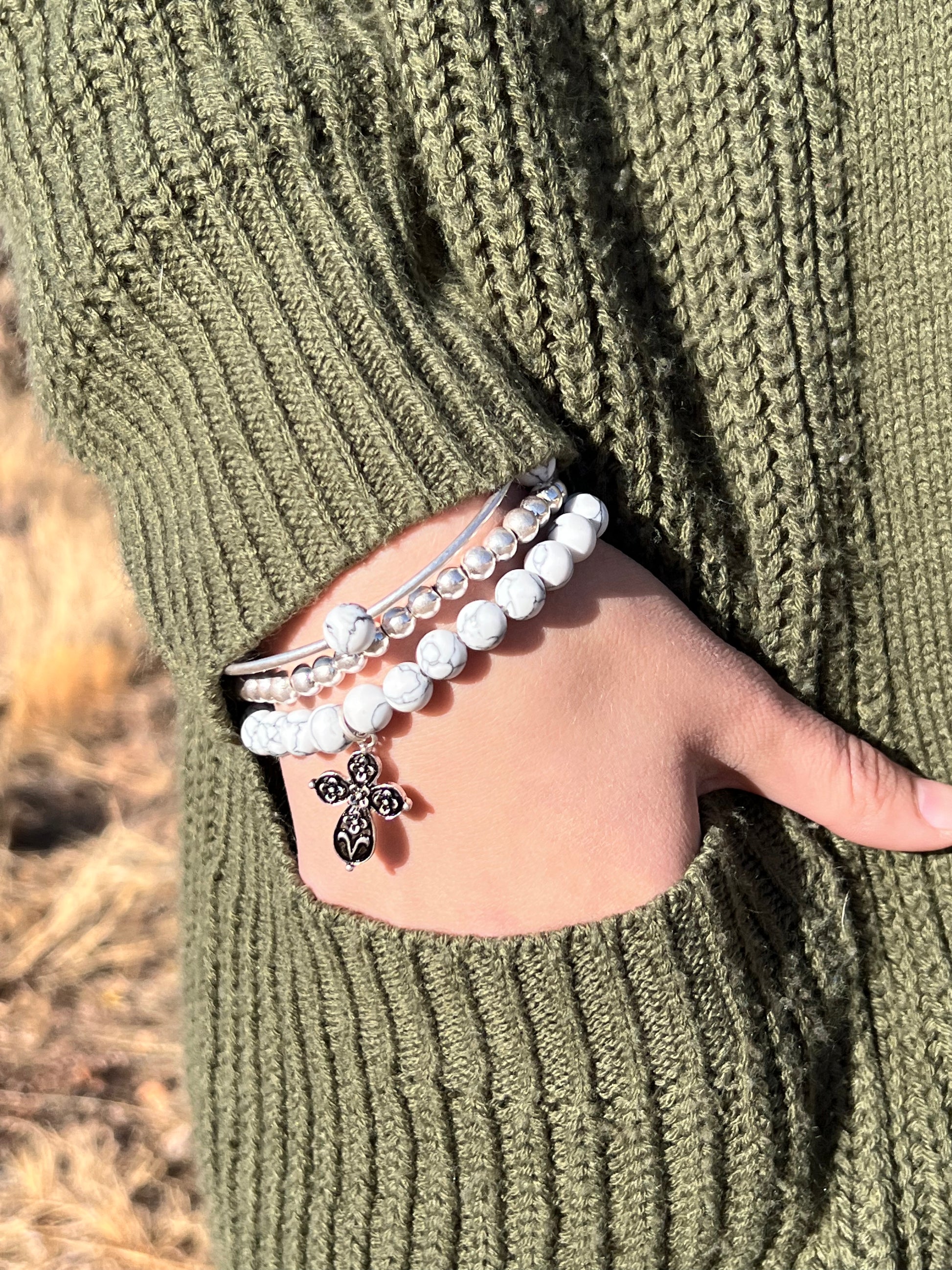 The faux stones, worn silver tone, and metal beads go together so beautifully. There is also a 1.5" engraved metal cube. A .75" heart charm and a 1" floral cross charm. Each bracelet is a comfort stretch so there is no closure. That allows for easy on and off. 2.25" diameter.  