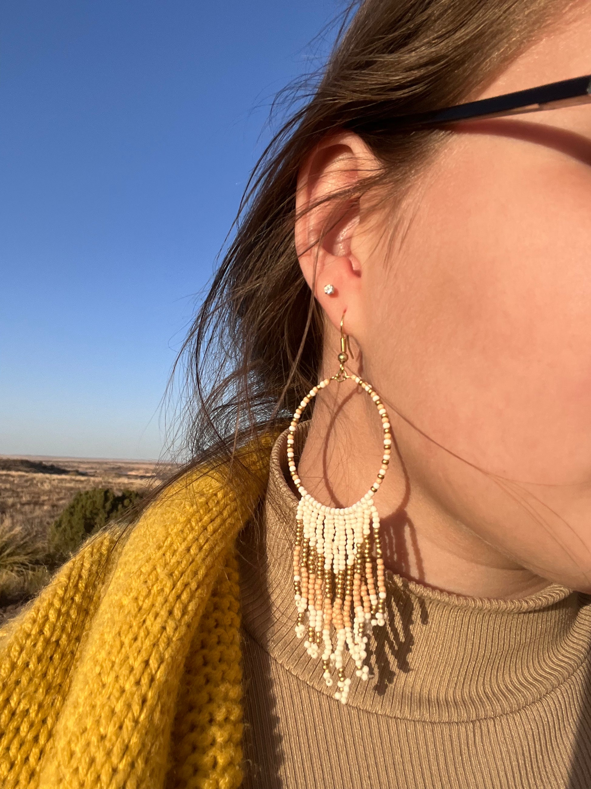  Seed beads are becoming a trendy theme. They would be a great gift to the earring lover as well.  They are approximately 4.5" fish hook style earrings with a 3.75" drop. The seed beads are ivory and gold tone with gold tone hardware. 
